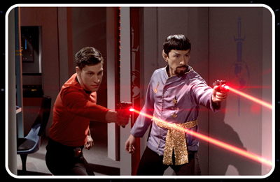 Two men in sci-fi uniforms aim red laser pistols in a futuristic setting.