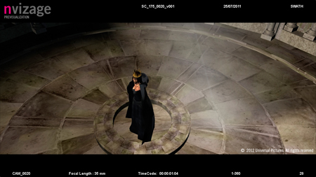 A person in a long black cloak and gold crown stands in the center of a circular stone floor.