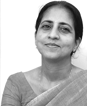 Black and white portrait of a woman with dark hair pulled back, wearing a sari and a necklace.
