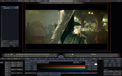 Video editing software interface displaying a film scene of a person in a hat in a dimly lit room.