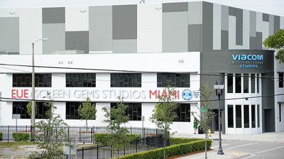 A large white and grey studio building with signage for EUE/Screen Gems Studios Miami and Viacom International Studios.