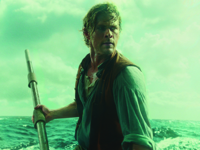 A man in a vest holding a long metal pole on a boat amidst choppy water under a green sky.