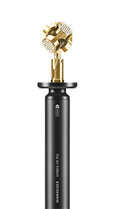 A Sennheiser Ambeo VR microphone with a gold-colored spherical capsule on a black stand.