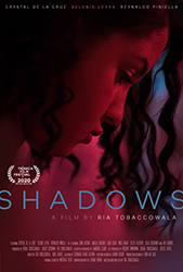 A close-up profile of a woman's face in dramatic red and blue lighting for the film Shadows.