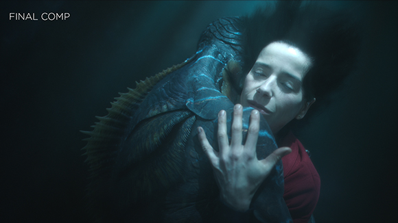 A woman with dark hair embraces a large, textured blue sea creature in dark underwater lighting.