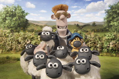 A claymation man wearing sunglasses smiles behind a group of several sheep in a grassy field.