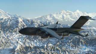 Dark military transport plane flying over a vast, snow-covered mountain range under a clear sky.