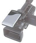 A silver and black electronic device mounted on top of a black video camera.