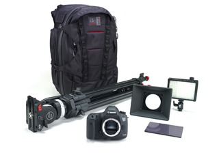 A black camera backpack, tripod, DSLR camera, LED light panel, and lens hood on a white background.