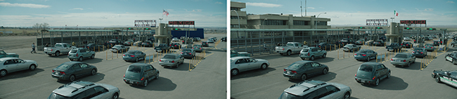 A large parking area and checkpoint filled with cars and trucks under a clear sky.