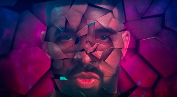 A man's face fragmented by sharp, geometric shards of glass against a dark pink and purple background.