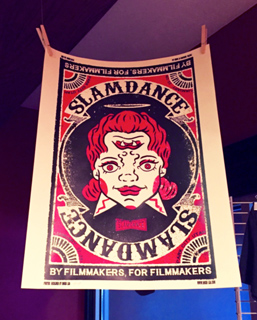 Poster for Slamdance film festival with a stylized face with three eyes and a halo. Text reads 'Slamdance by filmmakers, for