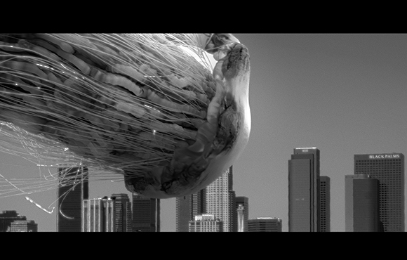 A large jellyfish floats in the sky above a silhouette of city skyscrapers.