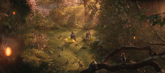 A woman in a yellow dress sits in a forest clearing surrounded by small woodland animals.