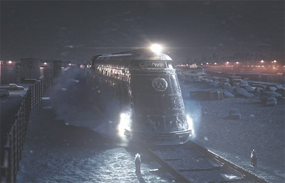 A dark train with bright headlights traveling through a snowy field at night.