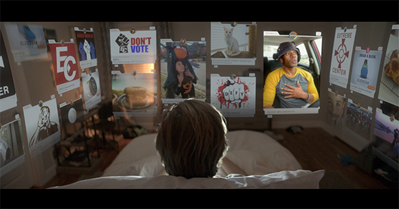 A person lies in bed facing a wall covered in various digital images, posters, and social media-style posts.