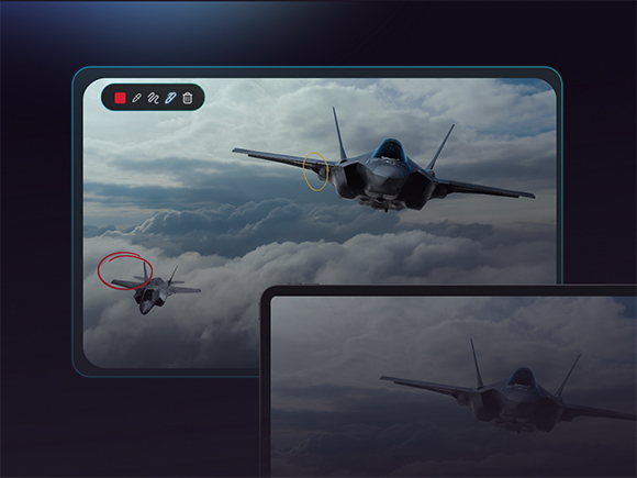 Two fighter jets flying through a cloudy sky on a tablet screen with editing tools visible.
