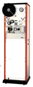 A tall, white reel-to-reel tape recorder with orange side panels and a large black reel on top.