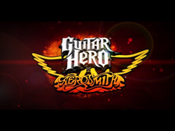 Guitar Hero Aerosmith logo with stylized text and golden wings against a dark, fiery background.