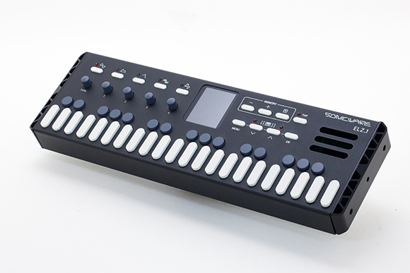 A black Sonicware ELZ1 synthesizer with white keys, blue buttons, and a small digital screen.