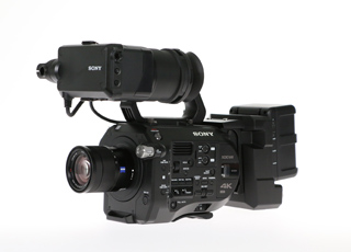 A black Sony professional video camera with a large lens and an attached top-mounted viewfinder.