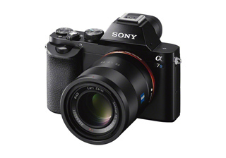 A black Sony Alpha 7S mirrorless camera with a large Carl Zeiss lens against a white background.