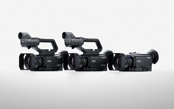 Three black Sony 4K professional video cameras arranged in a row against a light gray background.