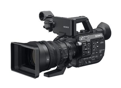 A black Sony professional 4K video camera with a large lens and viewfinder against a white background.