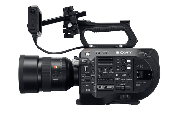 Side view of a black Sony 4K professional video camera with a large lens and an attached external monitor.