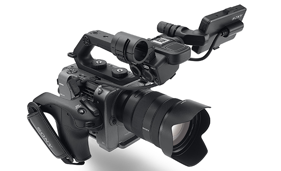 A black Sony professional cinema camera with a large lens and top-mounted monitor on a white background.
