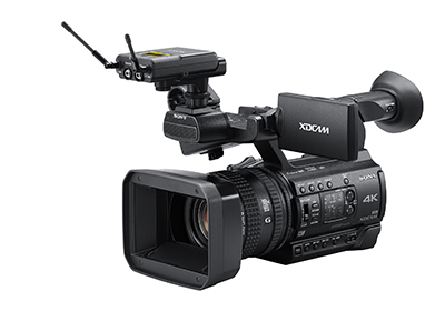 A black Sony XDCAM 4K professional video camera with an attached wireless microphone.