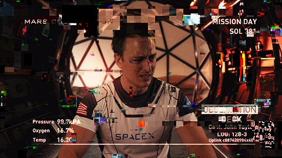A man's face with digital glitch effects and technical data overlays in a circular room.