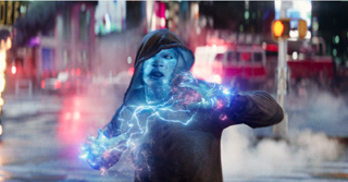 A hooded figure with glowing blue skin channels bright blue electrical energy in a city street.