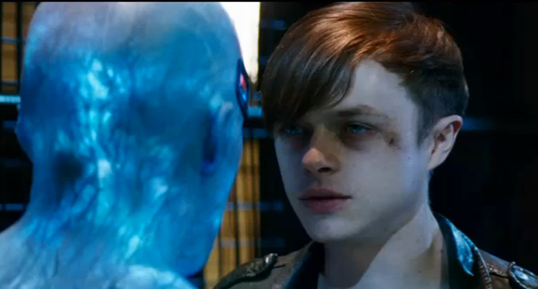 A young man with reddish-brown hair stares intensely at a glowing, blue translucent figure.