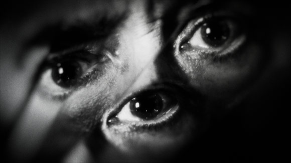 A black and white close-up shot showing several eyes looking in different directions.