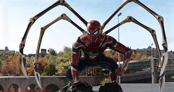 Spider-Man in a red and gold metallic suit crouches with four large mechanical spider legs extended behind him.