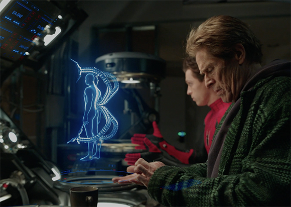 A man in a green sweater looks at a blue holographic human skeletal projection in a dark lab.