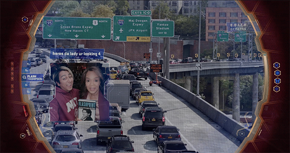 Digital HUD overlaying a view of heavy highway traffic and green road signs.