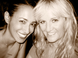 Two smiling women posing closely for a portrait in sepia tones.