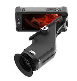 A black digital microscope attachment connected to the back of a smartphone with a red display.
