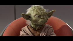 A small, green, wrinkled creature with large pointed ears sits in a red chair.