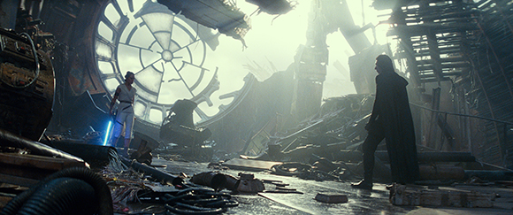 A figure in white stands near a blue light while a dark figure in a cape watches from across debris.