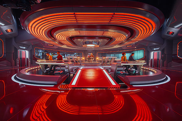 A high-tech command center with glowing red concentric circular lights on the ceiling and floor.