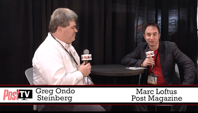 Greg Ondo Steinberg and Marc Loftus sit at a table with microphones during a PostTV interview.