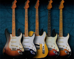 Five different electric guitars standing vertically against a dark blue patterned backdrop.