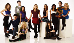 A group of ten young adults in fashionable clothing posing against a white background.