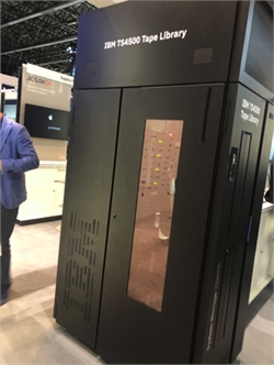A large, black IBM TS4500 Tape Library unit displayed at a trade show.