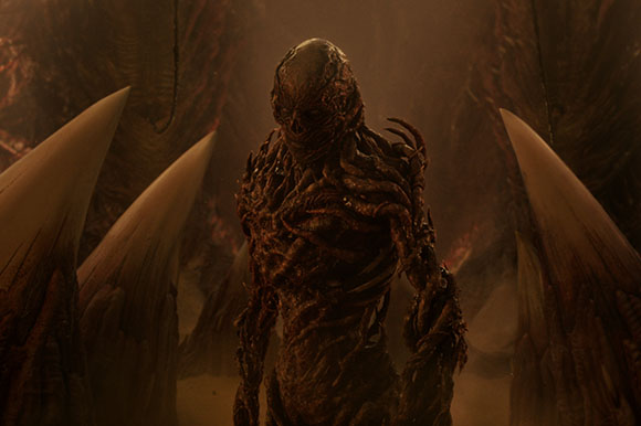 A dark, textured humanoid creature with a segmented body stands between large, sharp organic spikes.
