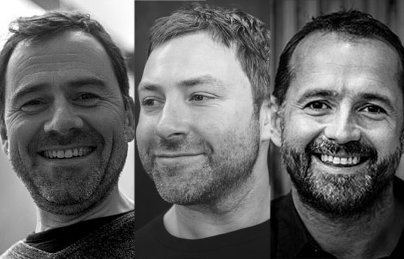 Three black and white close-up portraits of smiling men looking in different directions.