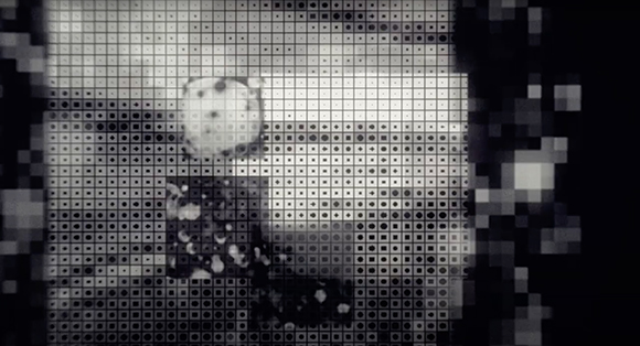 A black and white pixelated grid overlaying abstract dark and light shapes.